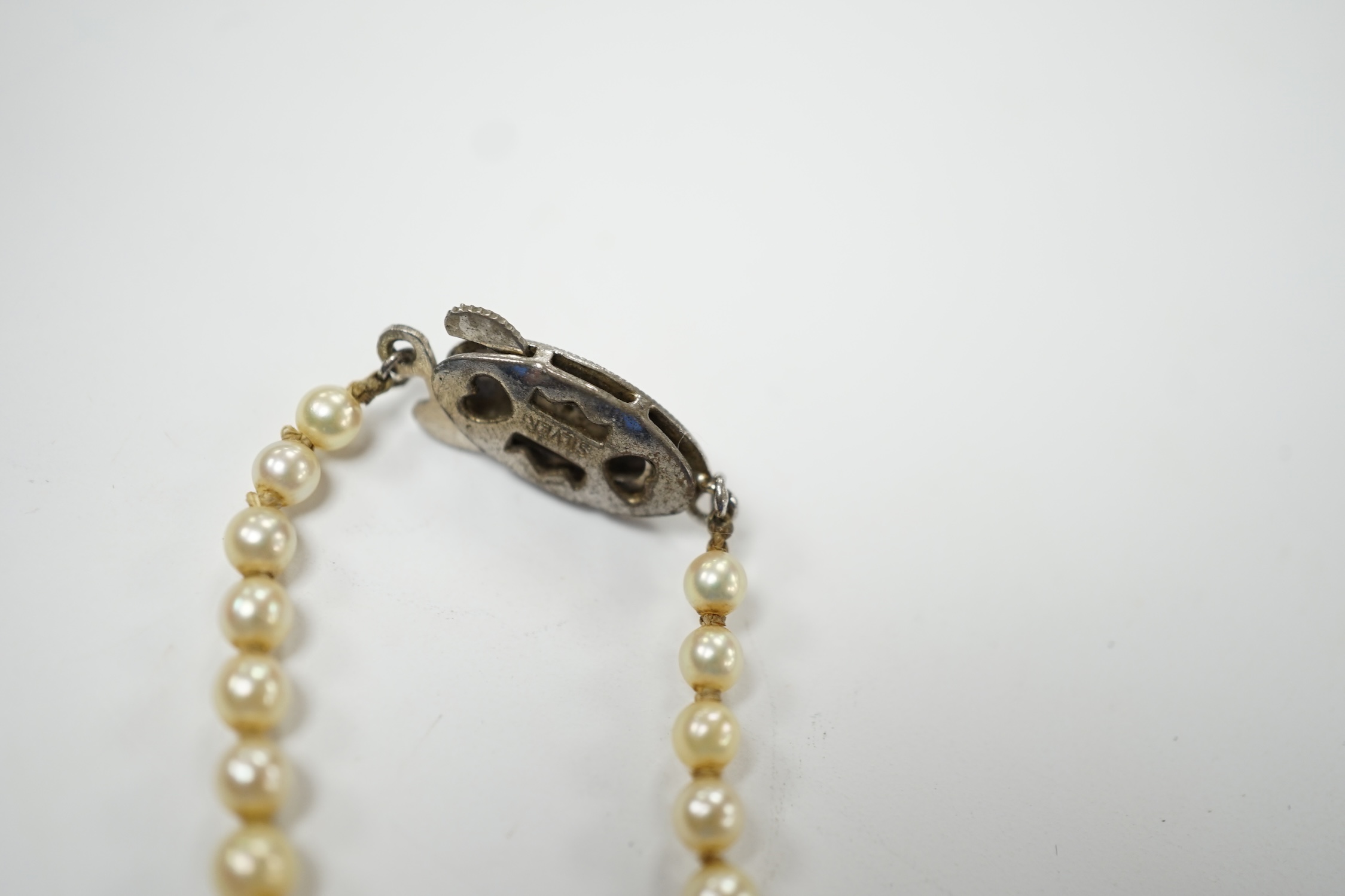 A single strand graduated culture pearl necklace, with cultured pearl set white metal clasp stamped 'silver', 38cm. Fair condition.